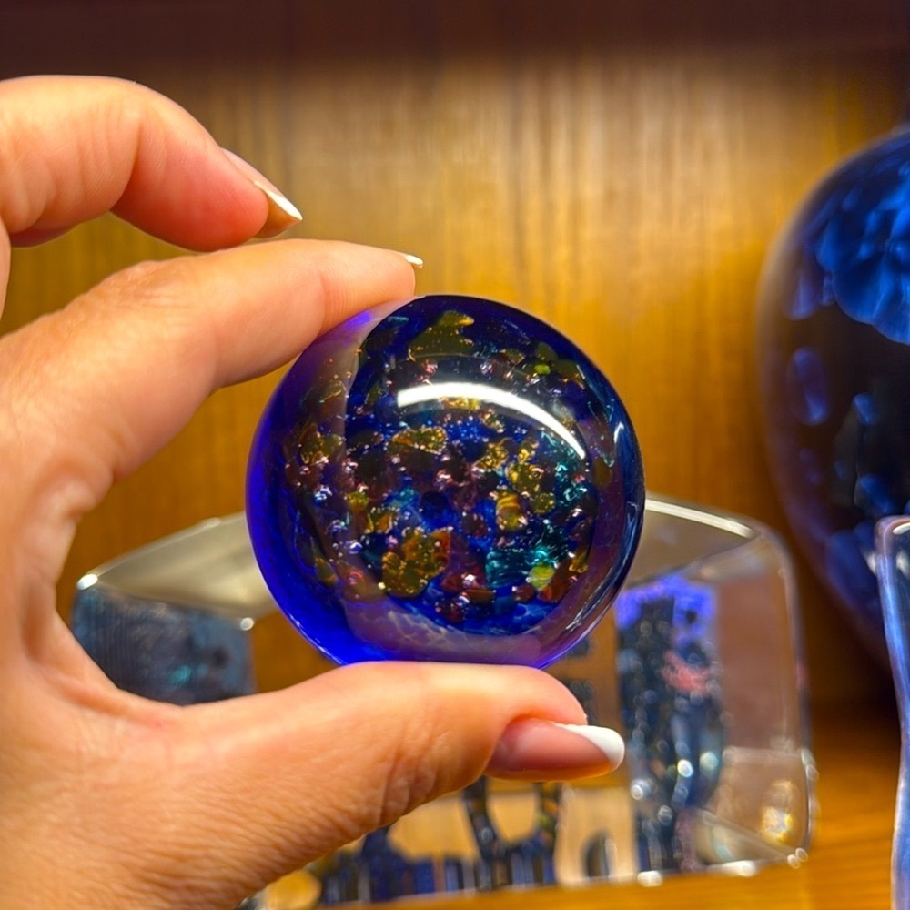 Robert held paperweight blue with multicoloured jewels, gorgeous